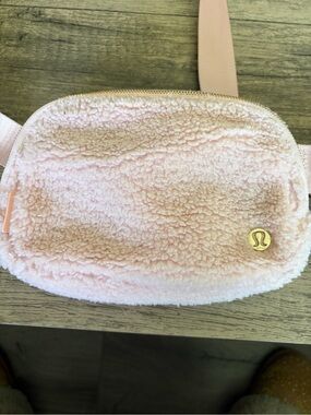 lululemon pale pink sherpa belt bag with gold zipper